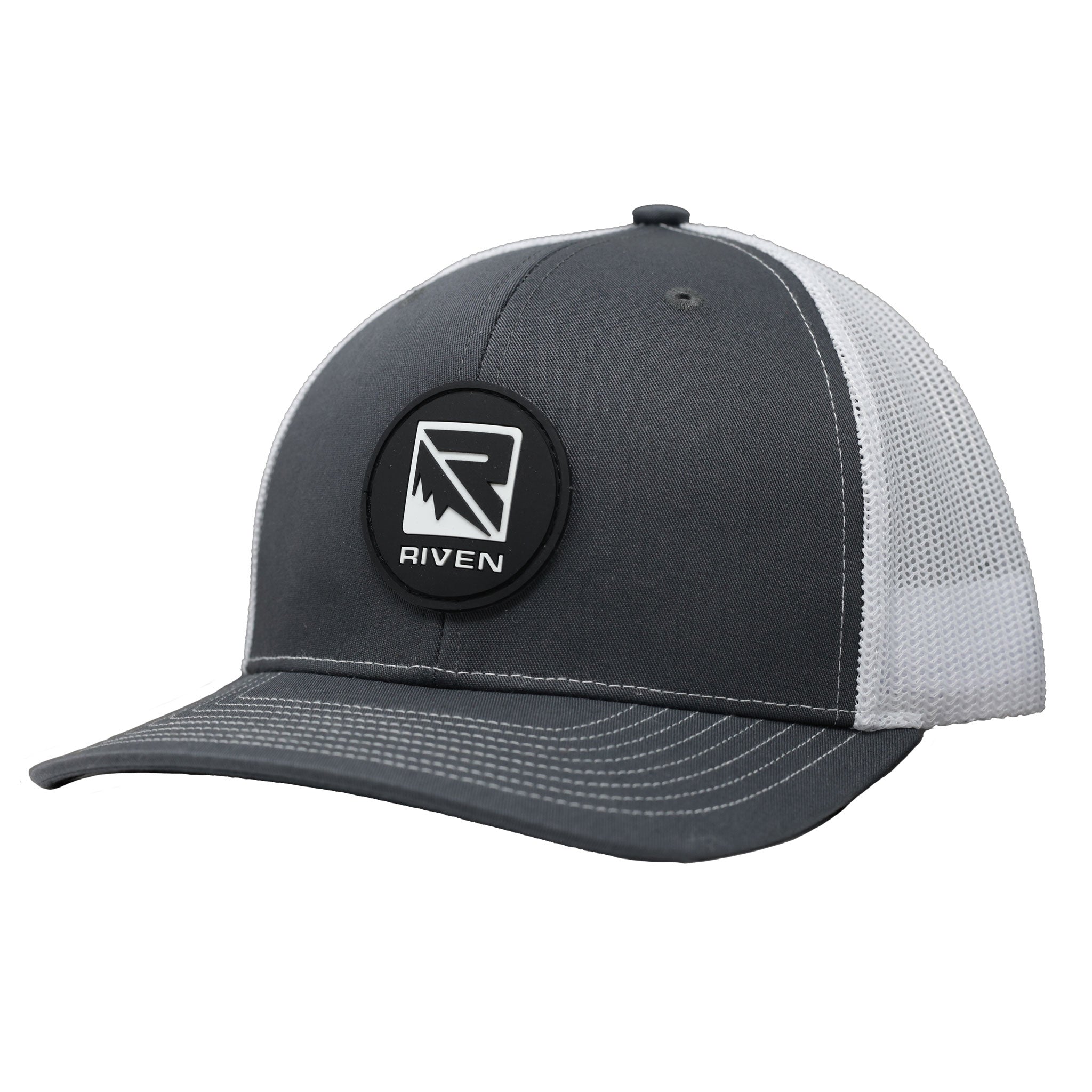 The Riven Patch Hat is a gray and white trucker hat with white stitching, mesh snapback, and a round black patch on the front featuring a stylized RIVEN logo. One size fits most.